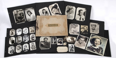 A collection of black and white photographs of celebrities surround a photo album with the word photographs.