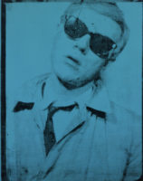 A screen print of Andy Warhol's face and chest. He has short, light hair and is wearing a light-colored shirt with a dark tie, a light-colored jacket and dark sunglasses. His head is tilted to the right and his mouth is slightly open. There is a blue tint to the entire screenprint.