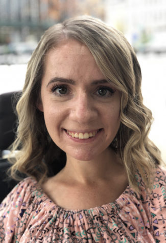 A woman is smiling at the camera.