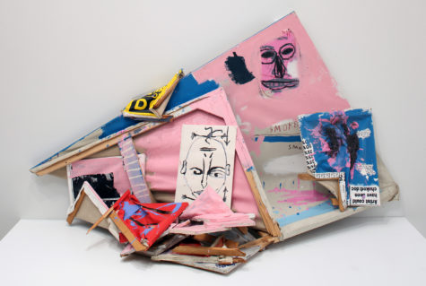 A 3-D mixed media artwork that contains a canvas and other small artworks of various sizes and colors.