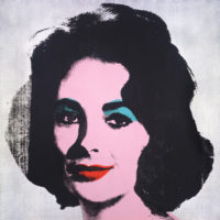 Screenprint of Elizabeth Taylor on a silver background. Her skin is bright pink, lips bright red, and she has bright blue eyeshadow.