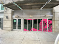 Rendering of a facade of a building with glass doors that has The Pop District logo on it and says, "The Warhol print annex" on the door.