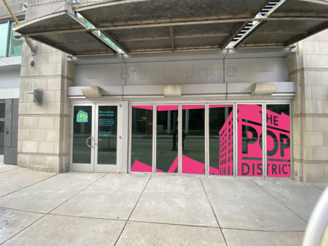 Rendering of a facade of a building with glass doors that has The Pop District logo on it and says, "The Warhol print annex" on the door.