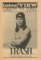 Front cover of Interview magazine that has a black and white photograph of Joe Dallesandro on the front from the waist up. He has long, dark hair, is wearing a dark headband, has his arms folded, and is looking towards the viewer. In the bottom left of the photo, it says, “Andy Warhol presents Joe Dallesandro in”. It says "Trash" in black at the bottom of the photo. Under that it says in smaller print, “including Jane Forth and Holly Woodlawn directed by Paul Morrissey. At the top of the cover, above the photo, it says, "Interview A Monthly Film Journal Volume 1, number 11 (out of NYC. 50¢) 35¢".