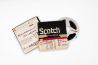 The front and back of Scotch reel-to-reel tape boxes with a reel-to-reel sticking out of the side of it.