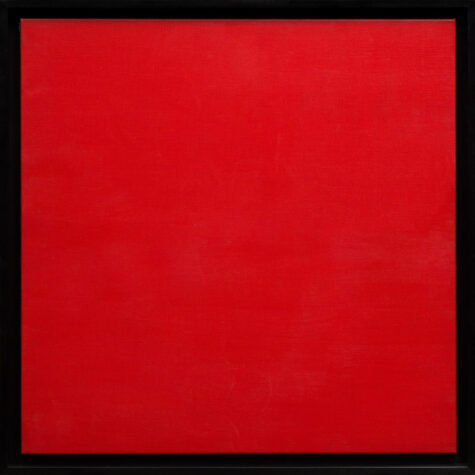 A square canvas painted red in a black frame.