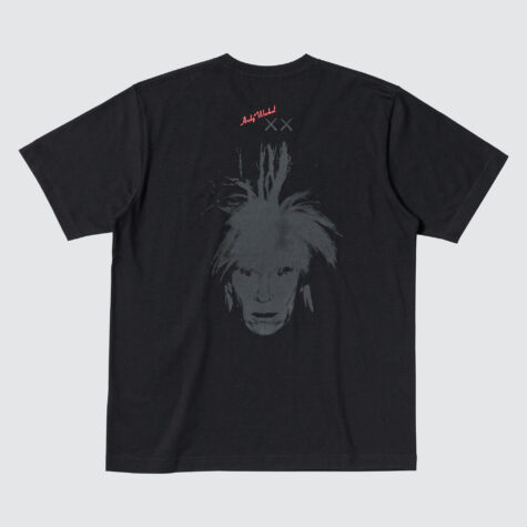 Black t-shirt featuring a white graphic print of Andy Warhol's self portrait artwork with chaotic hair with Andy Warhol's signature above in pink and "X X" below in gray.